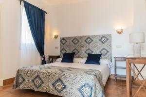 Postel nebo postele na pokoji v ubytování La Gitanilla Alojamiento & Encanto Jerez