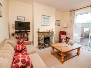 a living room with a couch and a fireplace at Eddystone in Kingsbridge