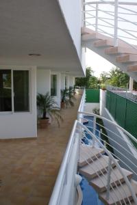 a balcony of a house with stairs and plants at Suites Moon River in Cancún