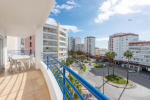 a balcony with a view of a city street at Apartamento Monarquia - T3 Quarteira in Quarteira