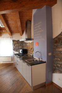 a kitchen with a sink and a stove top oven at Casa Trauner Mansarda Saba in Trieste