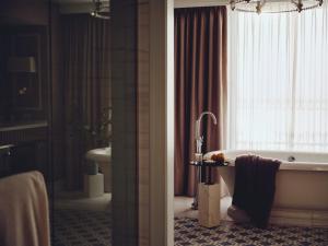 a bathroom with a bath tub and a window at Boston Harbor Hotel in Boston