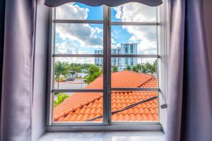 an open window with a view of a roof at Secret Garden Miami Beach in Miami Beach