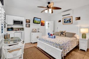 a bedroom with a bed, a desk, and a painting on the wall at Island Bay Resort in Key Largo