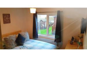 1 dormitorio con cama y ventana en Brambles Holiday Lodges, en Paignton