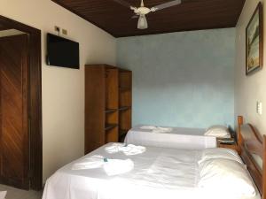 Ένα ή περισσότερα κρεβάτια σε δωμάτιο στο Hotel Pousada Nosso Cantinho +33 φωτογραφίες