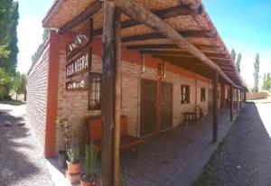 un edificio de ladrillo con toldo en el costado en Agua Negra en Las Flores