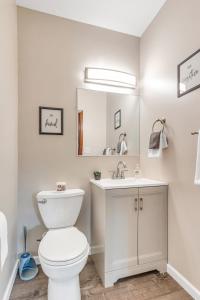 a bathroom with a white toilet and a sink at Spacious 3BR Home near Downtown, Oakland & East Liberty! Max 15 nights in Pittsburgh