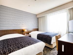 Кровать или кровати в номере APA Hotel Matsuyamajo-Nishi