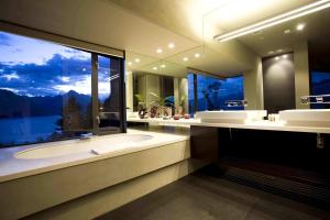 a large bathroom with a tub and a large window at Aspen Grove in Queenstown