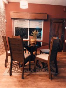 a dining room with a table and chairs and a window at El Refugio - Hotel Mariscala in Mariscala