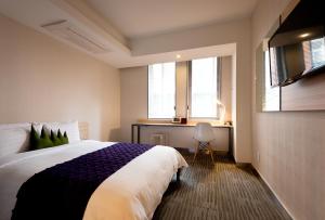 Postel nebo postele na pokoji v ubytování Metro Hotel Myeongdong