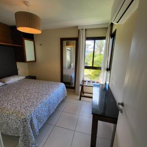 um pequeno quarto com uma cama e uma janela em VG Sun Cumbuco Bangalô E 201 adm Pessoa física em Cumbuco