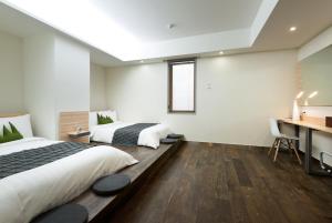 Postel nebo postele na pokoji v ubytování Metro Hotel Myeongdong