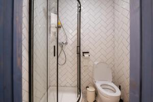 a bathroom with a toilet and a glass shower at Titmouse Hotel in Moscow