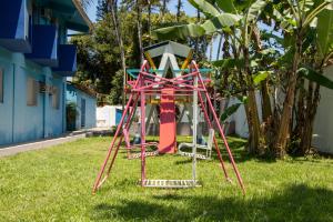 a playground in the grass in a yard at MOVA - Hotel Costa Azul in Ubatuba