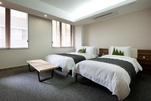 Postel nebo postele na pokoji v ubytování Metro Hotel Myeongdong