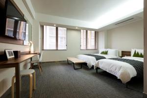 Postel nebo postele na pokoji v ubytování Metro Hotel Myeongdong