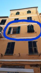 a building with a blue circle on the side of it at Angilina's apartment in Vernazza
