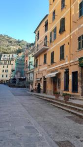 an empty street in a city with buildings at Angilina's apartment in Vernazza