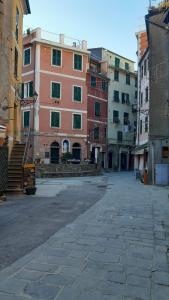 an empty street in a city with tall buildings at Angilina's apartment in Vernazza