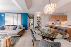 a dining room and living room with a glass table at Grenada Condo in Lower Woburn