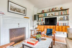 a living room with a fireplace and a tv at Lake Oswego Mid-Century in Lake Oswego