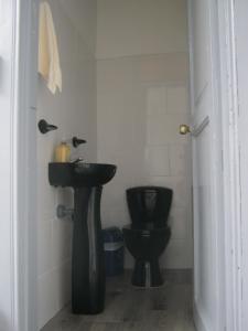 bagno con servizi igienici neri e lavandino di ANGIE`s HOUSE a Manizales