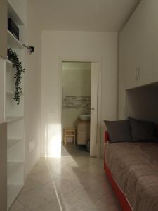 um quarto com uma cama e uma porta para uma casa de banho em Morena Studio Apartment em Asolo