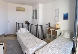 A bed or beds in a room at Amazing duplex with large terrace and sea views