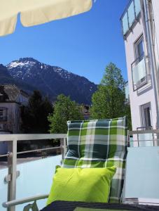 a chair on a balcony with a view of a mountain at Ferienwohnung Salzburg in Bad Reichenhall