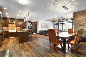 a kitchen and dining room with a table and chairs at Arrowleaf Lodge - 3 Bed Condo #311 in Park City