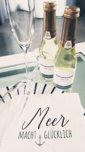 due bottiglie di vino e un bicchiere sul tavolo di Haus Möwenkind a Zirchow