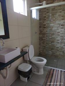 a bathroom with a toilet and a sink and a shower at KITNET DO PESCADOR 3 in Imbituba +12 photos