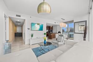 a living room with a white couch and a table at High Rise Luxury Ocean Corner Unit 2/2 - Icon Brickell in Miami