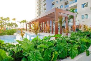 a garden of plants in front of a building at Apto Salinas Exclusive Resort, 2 quartos in Salinópolis