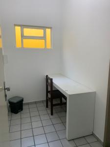 a room with a table and a chair on a wall at Amarante Hotel in Juazeiro +13 photos