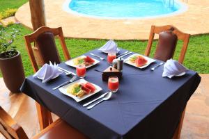 una mesa azul con platos de comida y bebida en Karanga River Lodge, en Moshi