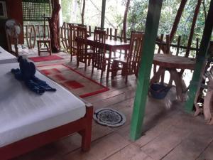 a kitchen with a table and chairs and a fire place at River Side Cabana in Tissamaharama