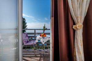 balcone con tavolo e vista sull'oceano di Apartments Tolic a Baška Voda