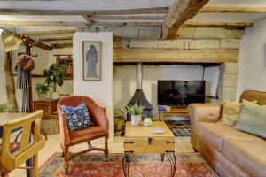 a living room with a couch and a table at Tudor Cottage by Spa Town Property - Historic Charm in Warwick Town Centre in Warwick