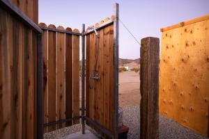 an open gate in a wooden fence at Family Style Star gazing Yurt in Twentynine Palms