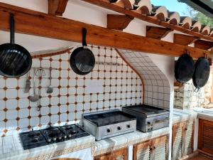 a kitchen with a stove and pots and pans at Casa Cachito in Benissa