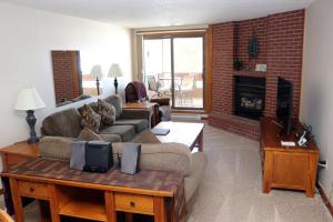 a living room with a couch and a fireplace at Spinnaker at Lake Dillon in Dillon