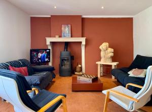 a living room with a couch and a fireplace at La Villa Maranges in Dezize-lès-Maranges