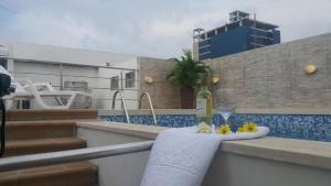 a bottle of wine and a glass on a towel at Hotel Oxford Barranquilla in Barranquilla