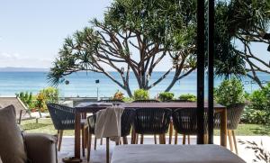a table and chairs with a view of the ocean at Noosa Court Apartment 4, Noosa Heads in Noosa Heads