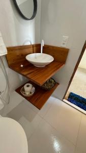 a bathroom with a sink and a toilet at Pousada Azul Blue in Amontada