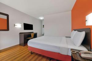 a hotel room with a large bed and a desk at Motel 6-Columbus, GA in Columbus