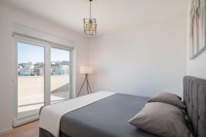 een slaapkamer met een bed en een groot raam bij Luxury penthouse Papic in Split